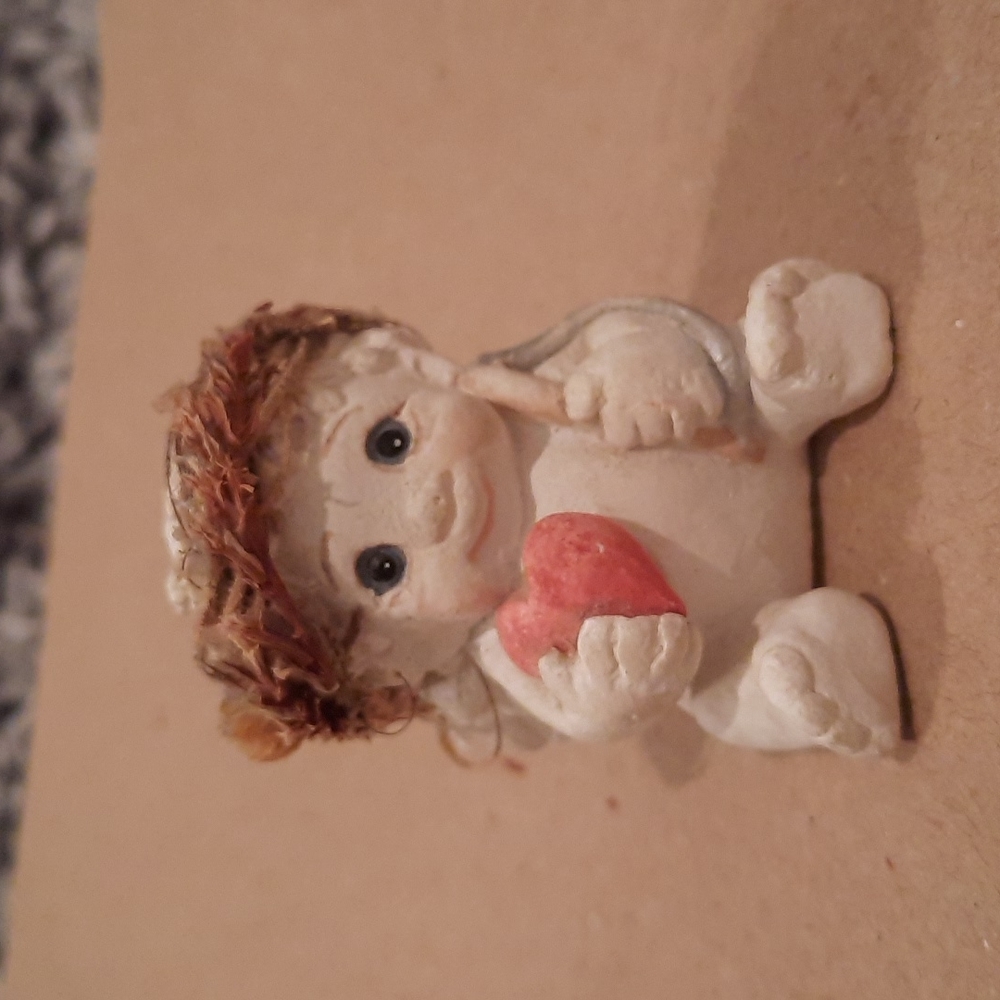 Dreamsickle ceramic collectible angel holding a heart